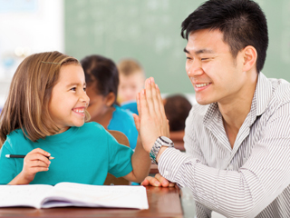 teacher giving high five to student