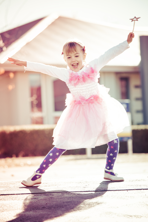 young girl dancing with wand