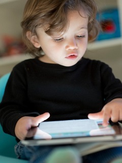 toddler playing with IPad