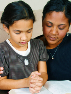 Mother and daughter praying