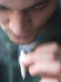 young man smoking marijuana